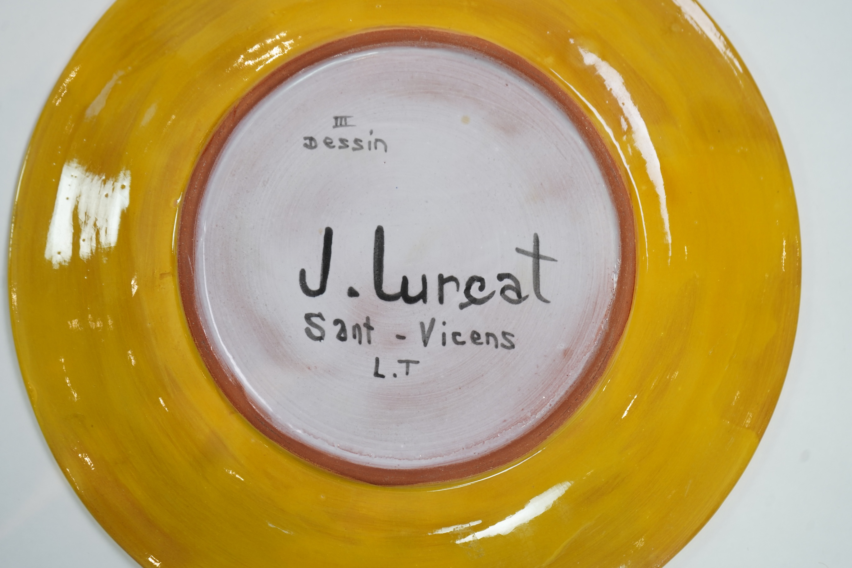 Jean Lurçat (1892-1966): A yellow glazed earthenware plate, decorated with a stylised central figure